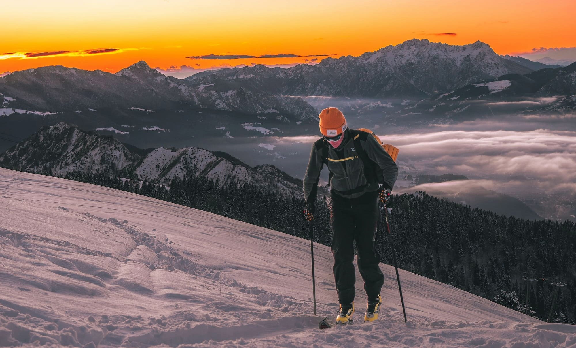 Skier carving through fresh Colorado powder at sunrise